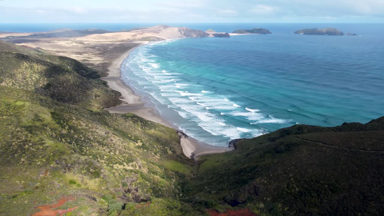 Drone view of beaches, Te Paki giant sand dunes, ocean waves and green coast on a sunny day in Cape Reigna, Northland, New Zealand.