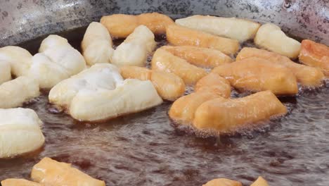 sequential frying of dough turning golden brown