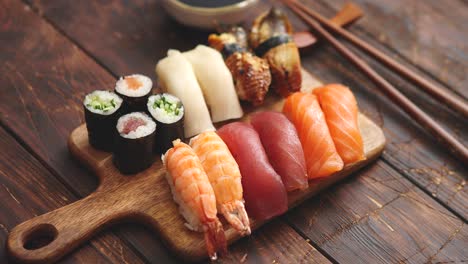 Sushi-Set--Different-kinds-of-sushi-rolls-on-wooden-serving-board