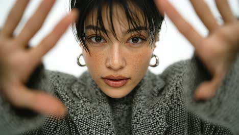 model posing with hands near face in slow motion