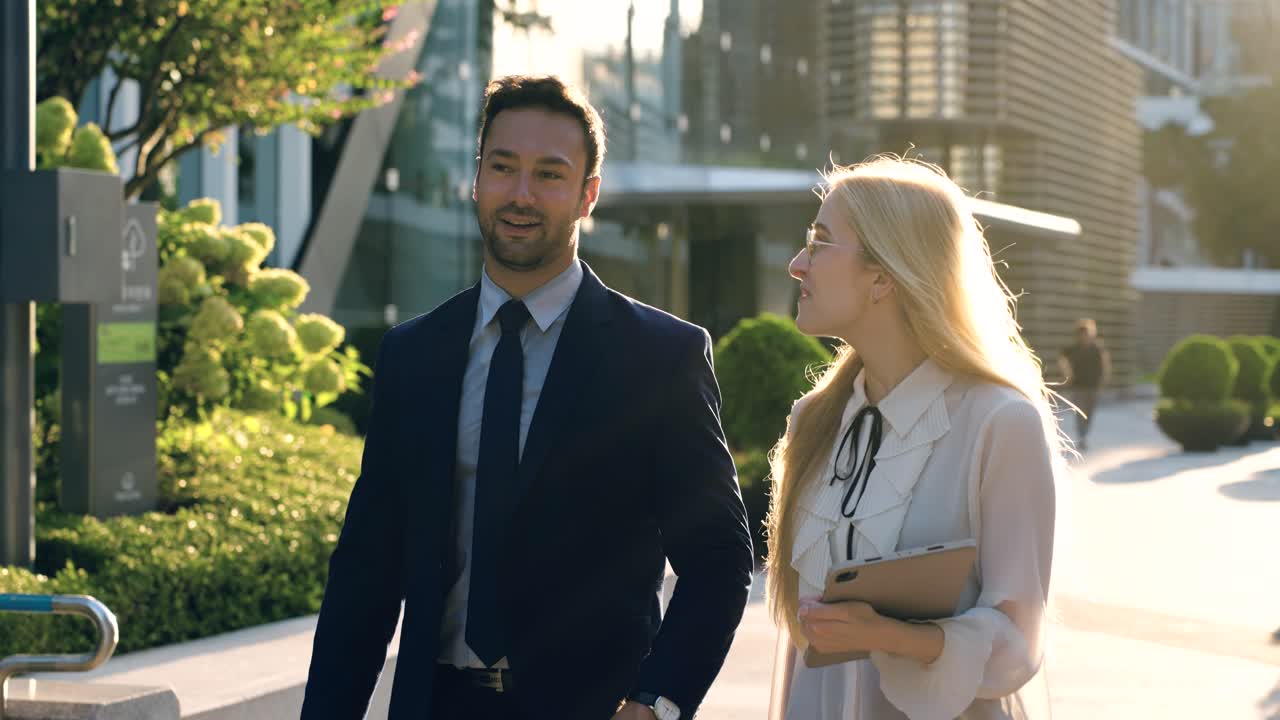 Happy Business People Coworkers Walking Together Chatting on the Go After Work at Sunset - slow motion