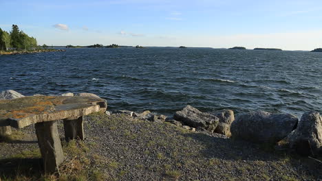 Pan-on-a-sea-coast-with-benches-in-a-windy-Finnish-fjord