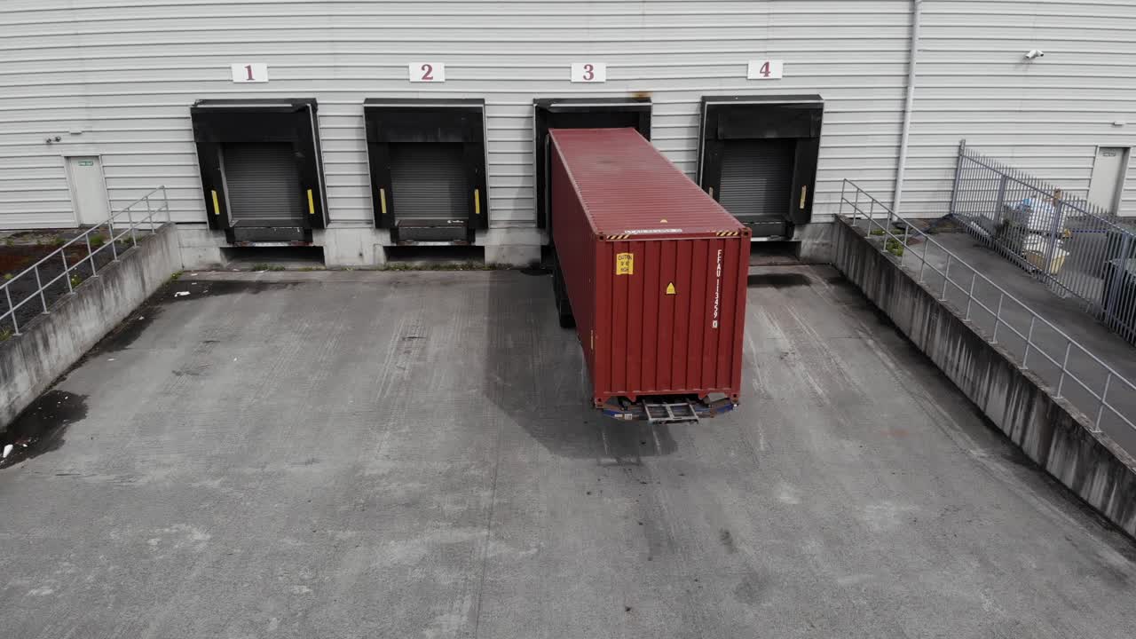 A Red Container Van At The Loading Bay Of A Warehouse In Dublin, Ireland - planning shot