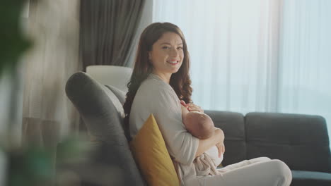 mother breastfeeding baby at home