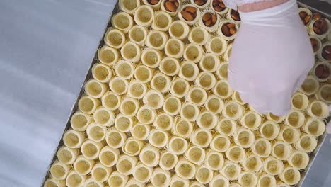 the chef of oriental sweets adds almonds to the dough to make osh al-bulbul sweets