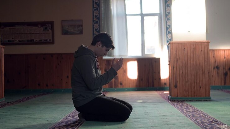 Muslim Man Kneels and Prays in A Mosque 2