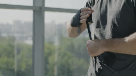 man wrapping boxing wrist wraps