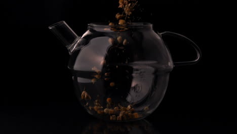 herbal tea pouring into glass teapot