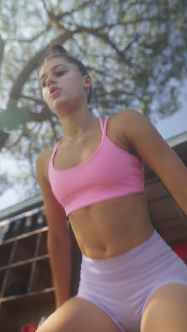 A young woman in activewear exercising outdoors