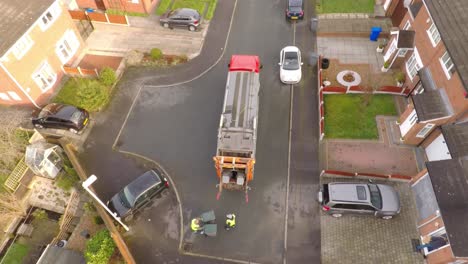 Aerial-View-of-Dustmen-putting-recycling-waste-into-a-waste-truck,-Bin-Men,-Recycling-day,-refuse-collection-in-Stoke-on-Trent,-Staffordshire