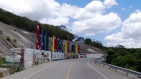 the city sign of san jose de ocoa, a city of the dominican republic being recorded while driving