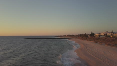 drone aerial view flying over hampton beach, australia melbourne, sun setting beautiful sky
