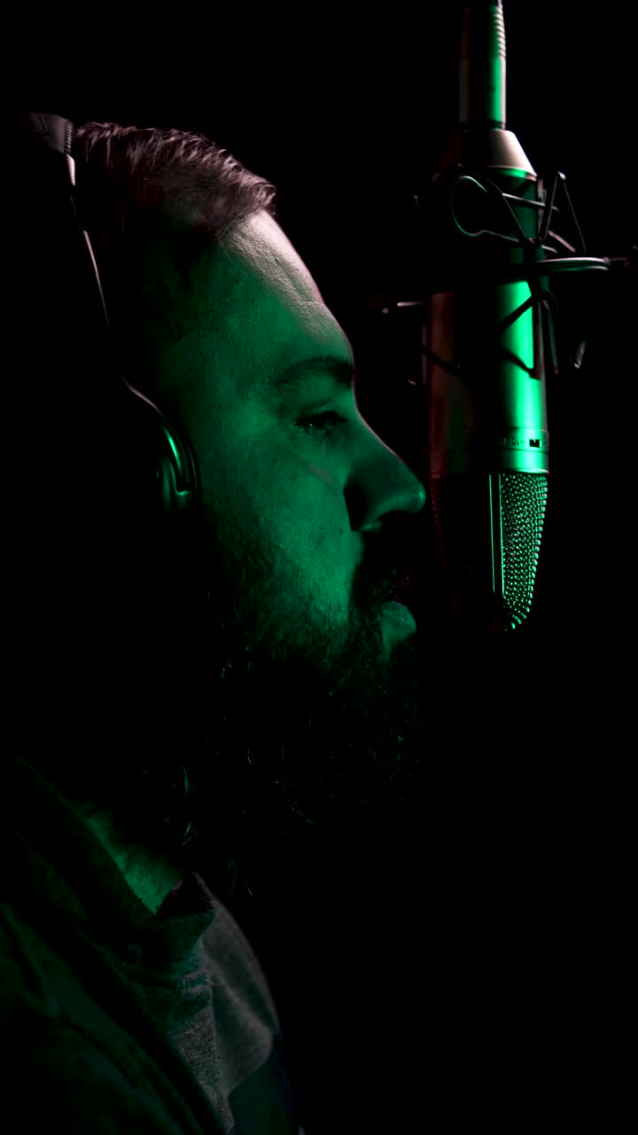 Vertical View, Man Speaking in Front of Microphone, Professional Podcast Studio Settings, Close Up