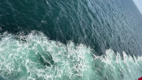 ferry travelling the english channel. blue water giving rise to a white waves