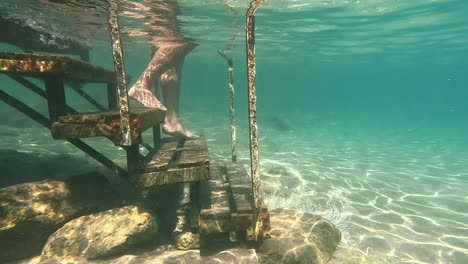 a man wading into the mediterranean sea at kardamena, kos, greece - underwater shot