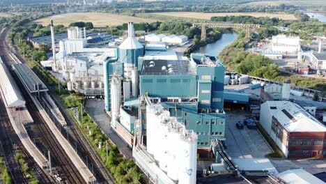 Industrial-chemical-manufacturing-factory-next-to-Warrington-Bank-Quay-train-tracks-aerial-descending-view