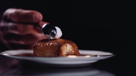 topping znoud el sit with a teaspoon of ashta cream - lebanese cuisine - close up