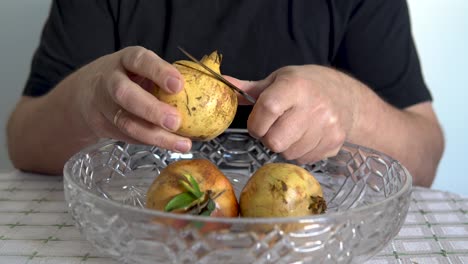 a man peels pomegranate. close-up. pomegranate healthy and sweet fruit