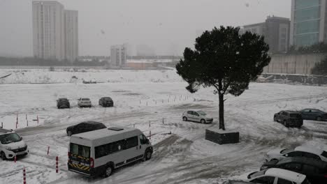 a snowy parking lot in a city