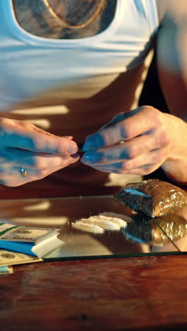 drug addict preparing cocaine lines. cocaine powder sorted. concept of drug abuse. social problems vertical video
