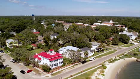 aerial push into town of southport nc, north carolina small town america