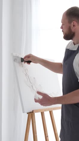a professional artist paints a picture