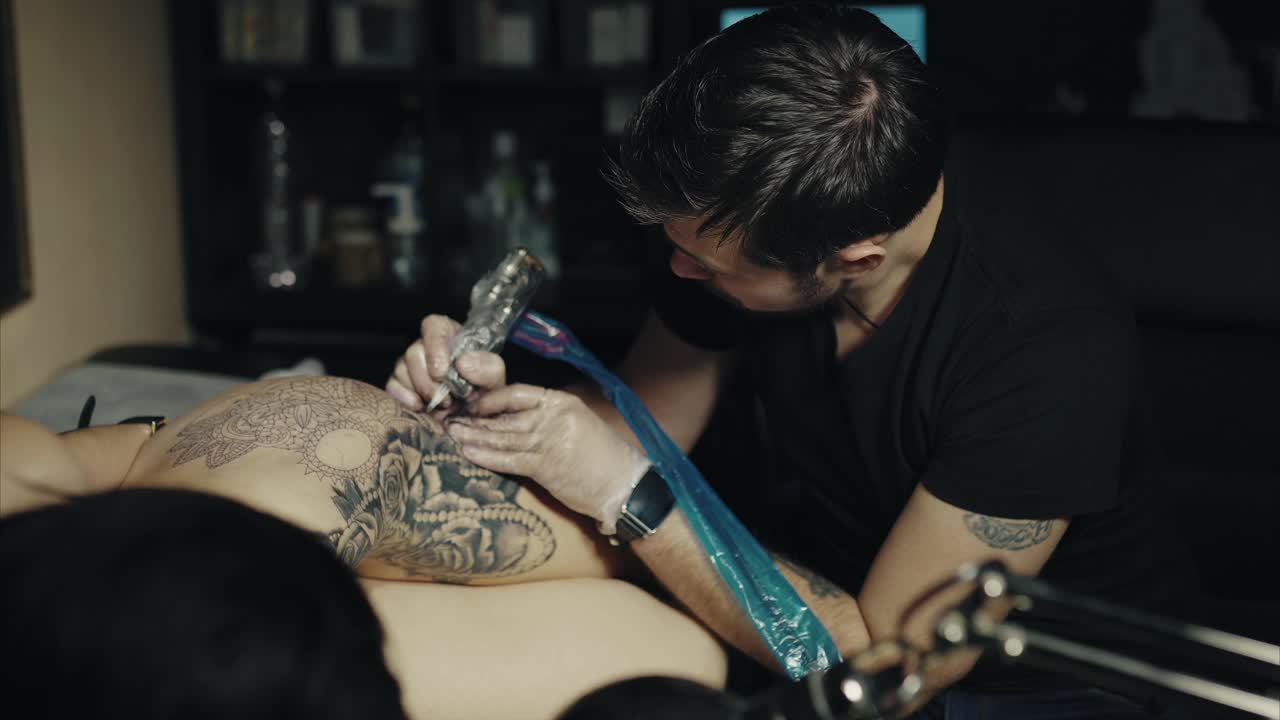 Tattoo Artist Working on a Mandala Design
