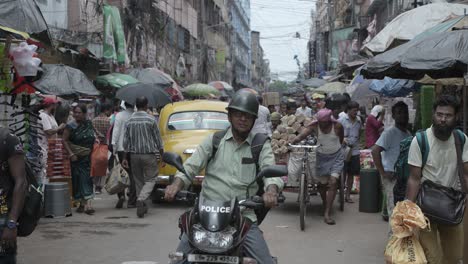 busy street scene in india with rickshaw puller
