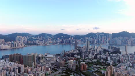 Hong-Kong-bay-and-skyline-with-skyscrapers,-high-altitude-wide-shot