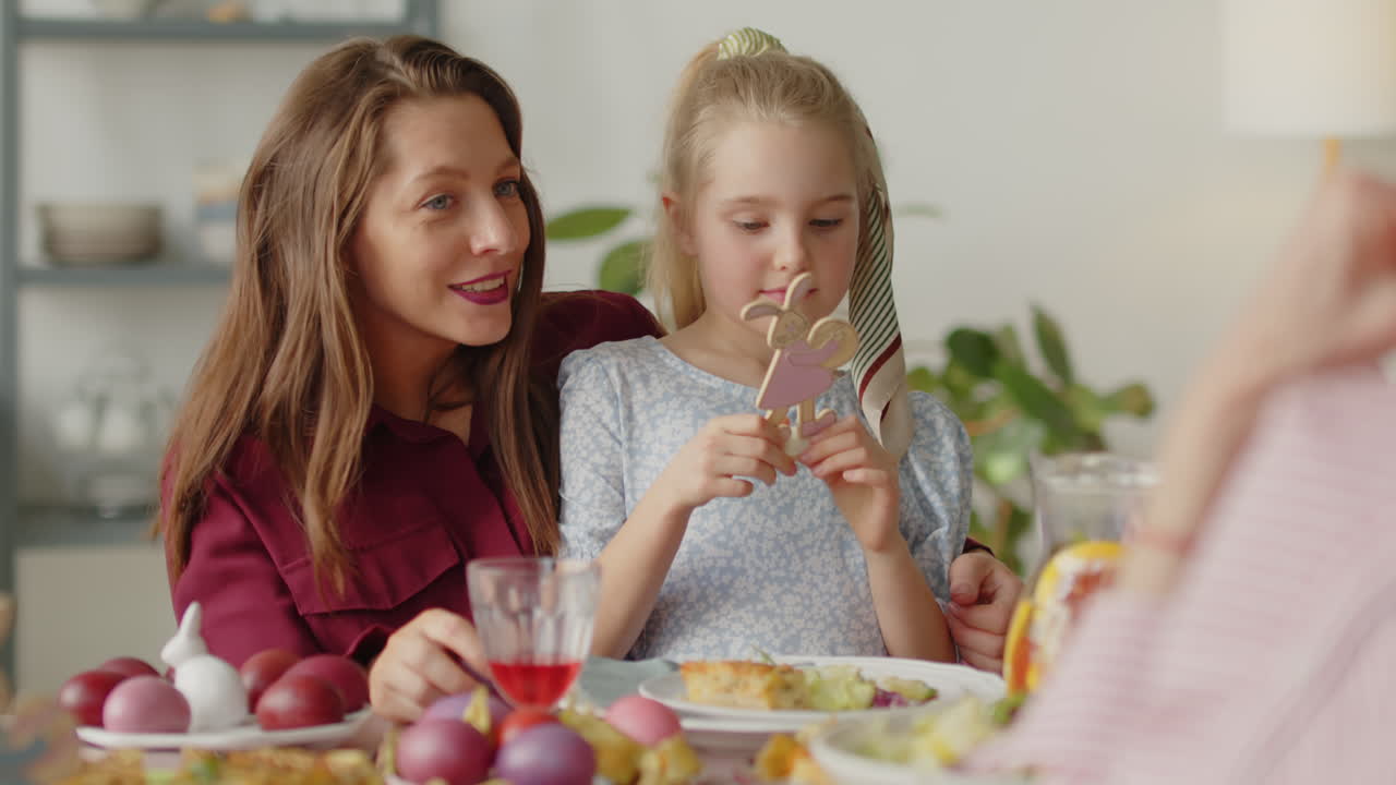Mother and Daughter Playing with Easter Toy on Dinner