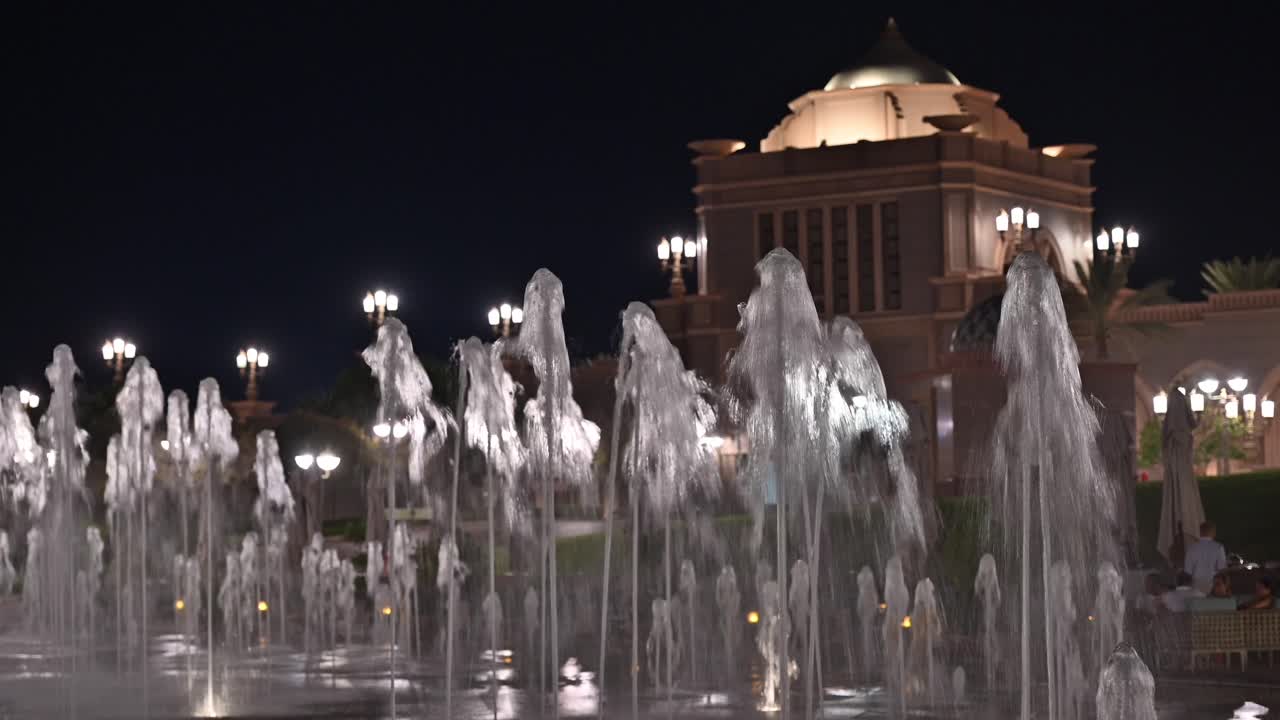 Emirates Palace Hotel lights up the Abu Dhabi skyline at night in the UAE
