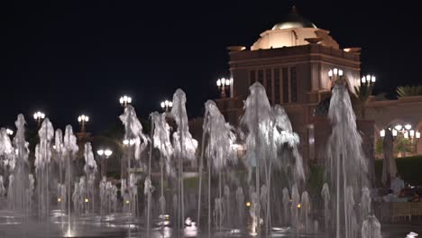 emirates palace hotel lights up the abu dhabi skyline at night in the uae