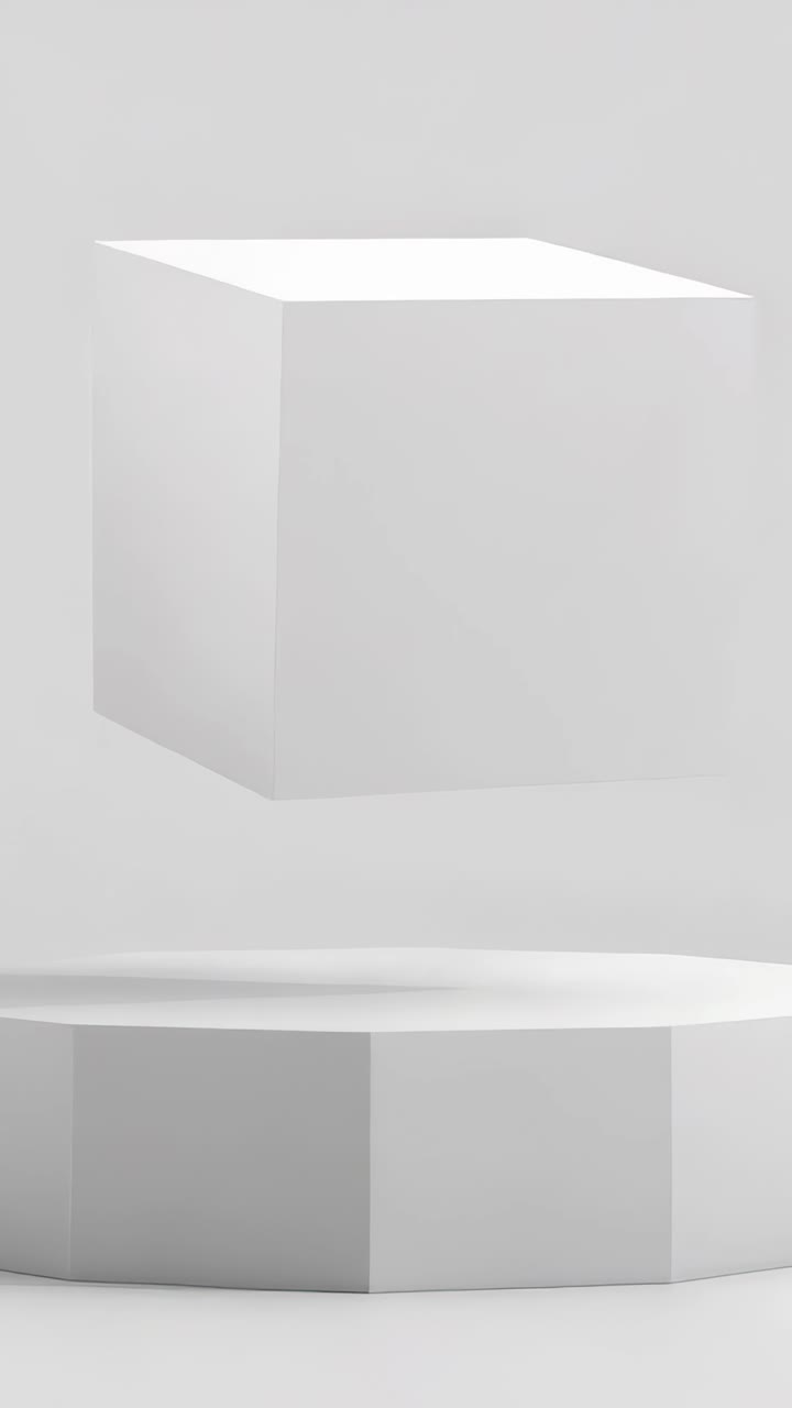 Vertical video: On play, white cube drifting and rotating above pedestal in studio, revealing faces