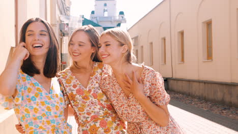 three friends laughing in a city street