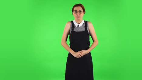 woman expressing surprise in front of a green screen