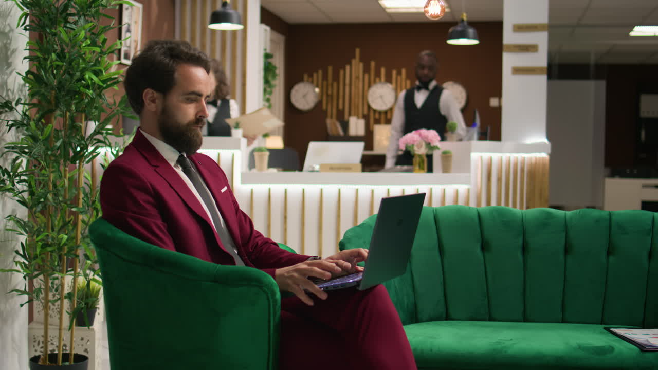 Employee uses laptop in lobby reception