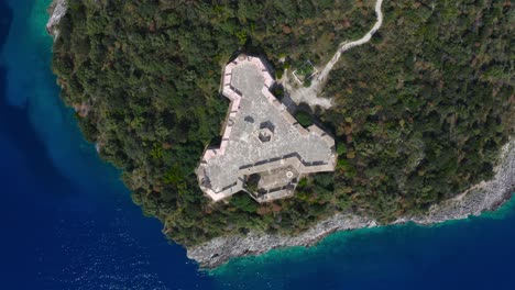 aerial top down view of triangular porto palermo castle, situated in the bay of porto palermo