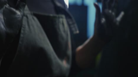 close-up of hands stained with dark substance
