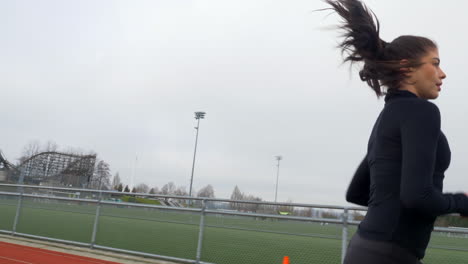 Sporty-Brunette-Running-on-Outdoor-Track