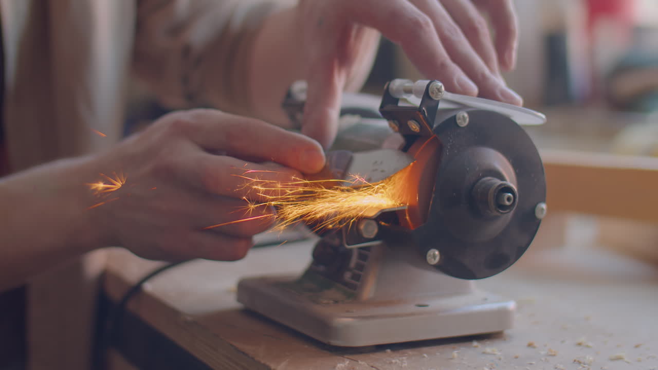 Carpenter Sharpening Knife with Grinding Jig in Workshop