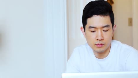 man using laptop at home 4k