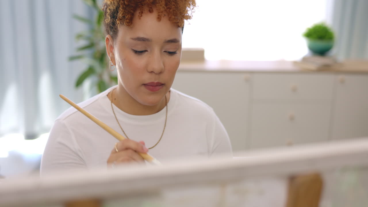 Artist, thinking and painting with brush