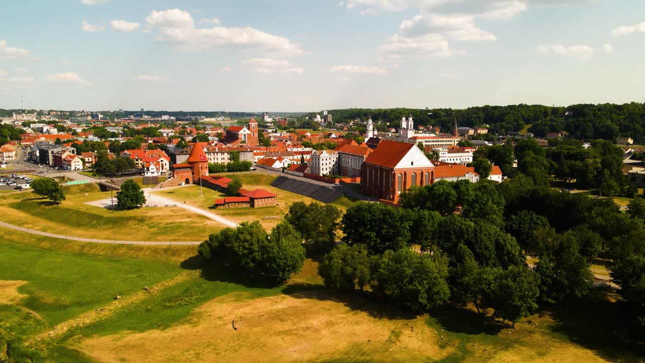 drone shot of Kaunas old town with Kaunas castle, churches and other old red roof houses in Kaunas, Lithuania on a sunny summer day