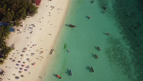 Beautiful-touristic-beach-with-umbrellas-and-boats-in-Zanzibar-tropical-island