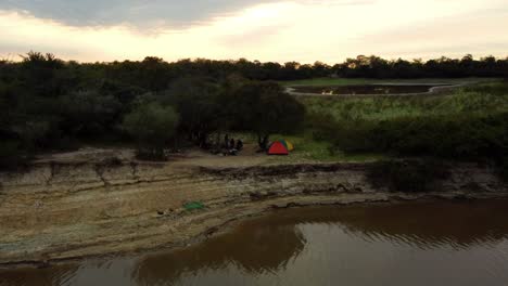 fishermen at dawn on a branch of the tebicuary river paraguay