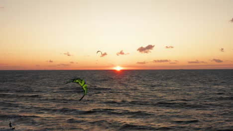 kitesurfers near the beach of domburg during sunset