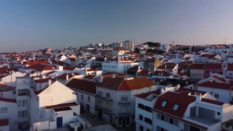 drone flyover residential buildings in ericeira village, portuguese coastline