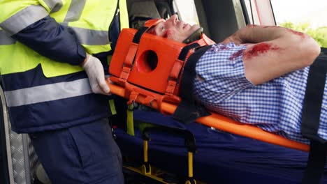 emergency medical technicians holding a wounded person