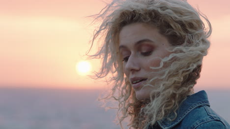 portrait of beautiful woman enjoying peaceful seaside at sunset contemplating journey exploring spirituality feeling freedom with wind blowing hair