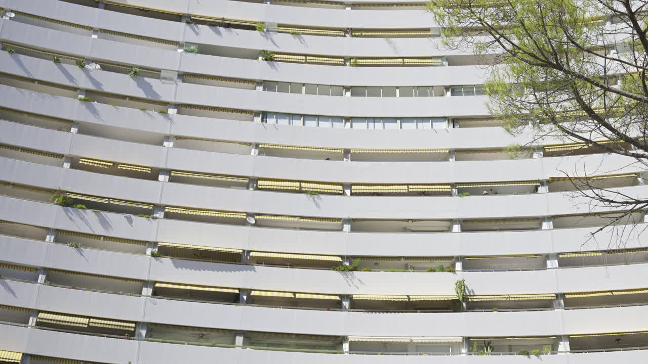Close up of the windows at the white, large, pyramid-shaped building in the Marina Baie des Anges complex in Villeneuve-Loubet, France